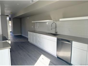 Modern kitchen featuring sleek white cabinets and stainless steel dishwasher at 1652 N Lafayette St # 6, Denver, CO 80218