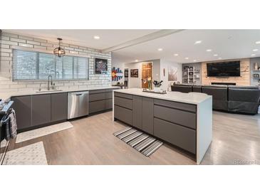 Spacious kitchen with an island and modern appliances, seamlessly connecting to the living area at 1025 Zang St, Golden, CO 80401