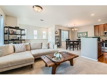 Spacious living area connecting the kitchen, dining space, and living room for easy entertaining at 13151 Grant N Cir # C, Thornton, CO 80241