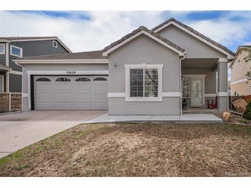 Charming single-Gathering home with a two-car garage and a covered front porch area at 19628 E 58Th Pl, Aurora, CO 80019