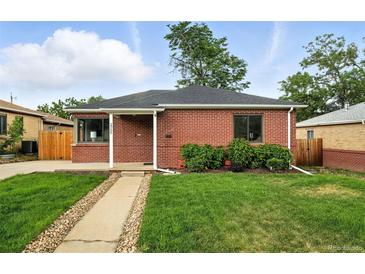 Charming brick home with a well-manicured front yard and a stone walkway leading to the entrance at 2955 Poplar St, Denver, CO 80207