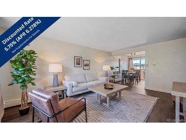 Inviting living room featuring stylish furniture, natural light, and an open floor plan with adjacent dining area at 3744 Miller Ct, Wheat Ridge, CO 80033