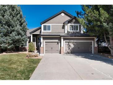 Charming two-story home with a three-car garage, landscaped yard, and neutral-tone exterior at 10028 Chelmsford Ter, Parker, CO 80134