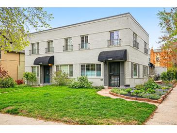 Charming two-story building with brick facade, tidy lawn, and landscaped garden beds flanking the entrances at 1100 Gaylord St, Denver, CO 80206