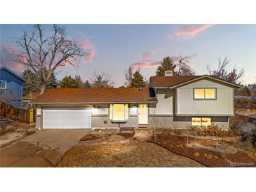 Charming home featuring a well-maintained front yard, attached garage, and neutral exterior paint at 13131 Mercury Dr, Lone Tree, CO 80124