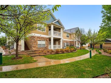 Inviting condo exterior with stone accents, private balcony, and well-maintained landscaping at 8200 E 8Th Ave # 5-204, Denver, CO 80230