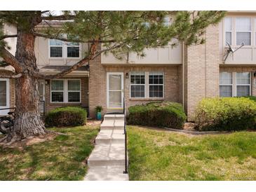 Charming brick townhouse featuring a cozy front porch and well-maintained landscaping at 3098 W 107Th Pl # C, Westminster, CO 80031