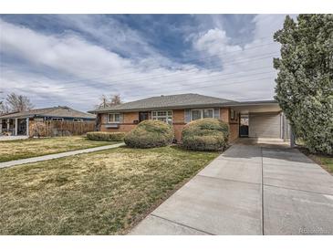 Charming brick home with a covered carport, mature landscaping, and a well-maintained front lawn at 170 S Fenton St, Lakewood, CO 80226