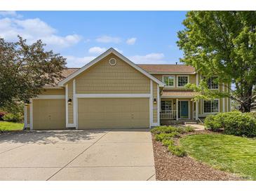 Charming two-story home with a three-car garage, manicured landscaping, and a welcoming entrance at 9346 Lark Sparrow Dr, Highlands Ranch, CO 80126