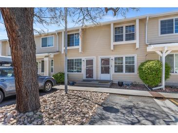 Charming townhome featuring a welcoming entrance and well-maintained landscaping with mature trees at 8915 Field St # 116, Broomfield, CO 80021