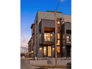 Modern townhome featuring a private balcony, sleek architectural design, and updated outdoor lighting at 2330 Eliot St # 3, Denver, CO 80211