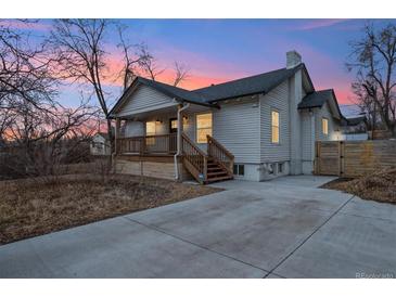Charming home featuring a quaint front porch, updated siding, and a spacious driveway at 6420 W 6Th Ave, Lakewood, CO 80214