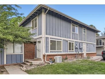 Charming exterior of a two-story townhome with a well-maintained lawn and classic architectural details at 13343 E Louisiana Ave, Aurora, CO 80012
