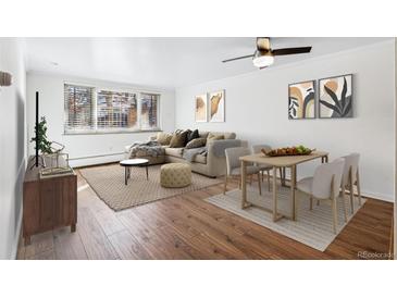 Living room with hardwood floors, natural light, comfortable seating, and dining area at 969 S Pearl St # 103, Denver, CO 80209