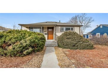 Cute bungalow with a landscaped yard and a welcoming front porch at 1017 Florence St, Aurora, CO 80010