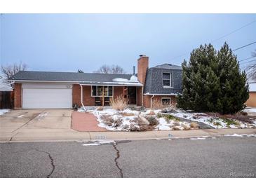 Charming brick home with a well-manicured front yard and attached garage at 10902 Bannock St, Northglenn, CO 80234