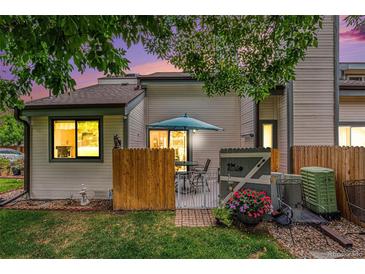 Cozy back patio with table and chairs surrounded by privacy fence and flowers at 8314 S Everett Way # B, Littleton, CO 80128