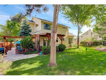 An inviting backyard features a stone patio and a lush green lawn perfect for outdoor entertaining at 1620 Oak Ave, Boulder, CO 80304