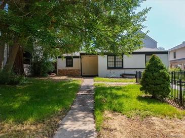 Charming single-story home with mature trees and a well-maintained front yard at 160 Monroe St, Denver, CO 80206