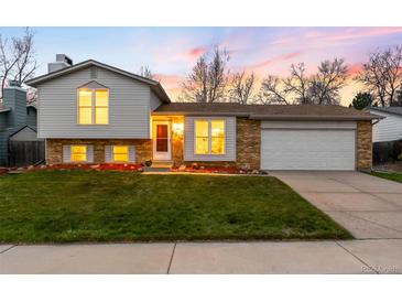 Charming home with a well-manicured lawn and lovely landscaping at 8512 W Star Cir, Littleton, CO 80128