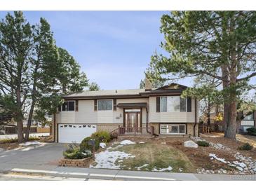 Ranch style home with attached garage and landscaped yard at 16994 E Bethany Pl, Aurora, CO 80013