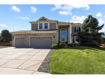 Charming two-story home featuring a three-car garage and a well-maintained front lawn at 11839 Saddleback Ct, Parker, CO 80138