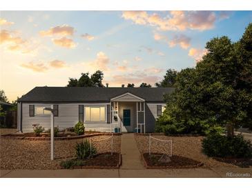 Charming single-story home with manicured front yard and inviting entrance walkway at 707 Uvalda St, Aurora, CO 80011