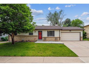 Charming ranch-style home featuring a cozy front porch, well-maintained lawn, and attached garage at 6508 S Garland Way, Littleton, CO 80123