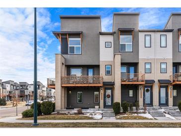 Modern townhome with a contemporary facade, private balconies, and a welcoming entrance at 10031 Town Ridge Ln, Lone Tree, CO 80124