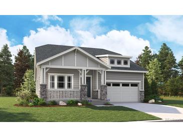 Charming single-Gathering home with a covered front porch and attached two-car garage in a well-manicured lawn at 8250 Snake River St, Littleton, CO 80125