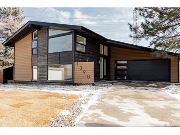 Beautiful contemporary home featuring a modern garage door and manicured yard at 1390 S Jasmine Way, Denver, CO 80224