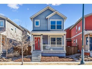 Charming two-story home featuring a red front door and inviting front porch at 5760 N Boston St, Denver, CO 80238