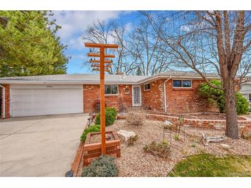 Charming brick ranch-style home with a well-maintained front yard and attached garage at 6334 S Elati St, Littleton, CO 80120