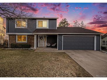 Charming two-story home featuring an attached two-car garage and well-maintained front yard at 7745 S Trenton Ct, Centennial, CO 80112