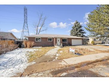 Ranch style brick home with attached garage and mature landscaping at 3931 S Uinta St, Denver, CO 80237