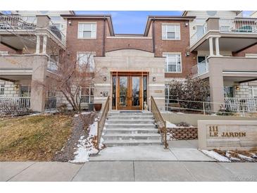 Beautiful building exterior with stone and brick and landscaped entrance at 111 S Monroe St # B203, Denver, CO 80209