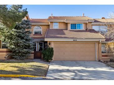 Charming townhome featuring a two-car garage and desert landscaping at 8822 Fiesta Ter, Lone Tree, CO 80124