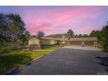 Spacious home with a three-car garage and well-maintained landscaping at 18680 Knollwood Blvd, Monument, CO 80132