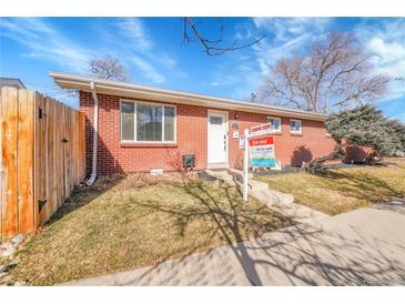 Charming brick home featuring a well-maintained front yard and 'Coming Soon' for sale sign at 4501 Bryant St, Denver, CO 80211