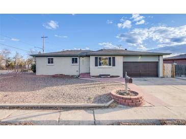 Charming single-story home with a well-maintained yard and attached garage at 8408 W 62Nd Pl, Arvada, CO 80004