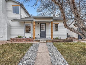 Charming exterior of a two-story home with walkway and a large tree at 2310 Willow Creek Dr, Golden, CO 80401