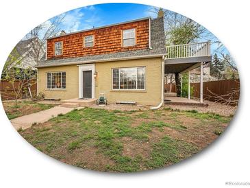 Charming two-story home with a unique wood-shingled upper level and inviting covered patio at 240 Colorado Blvd, Denver, CO 80206