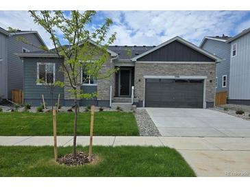 Charming single-Gathering home featuring a well-manicured lawn, stone accents, and an attached two-car garage at 2536 Lupton Ln, Lafayette, CO 80026