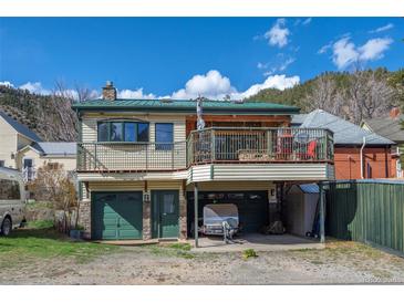 Two-story home featuring multi-car garage, and a second story deck at 829 Colorado Blvd, Idaho Springs, CO 80452