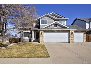 Charming two-story home featuring a three-car garage and stone accents, offering ample space and curb appeal at 9436 Cody Dr, Broomfield, CO 80021