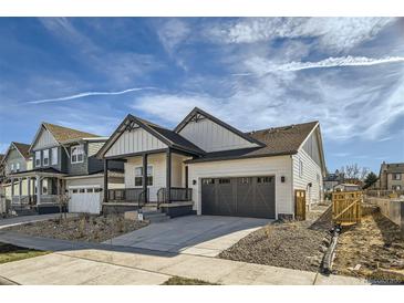 Beautiful two-story home with a covered porch, two-car garage, and well-maintained landscaping at 2750 E 102Nd Pl, Thornton, CO 80229