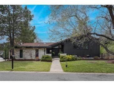 Stunning home with modern design elements, a red tiled roof, and a beautifully landscaped front yard at 5880 S Happy Canyon Dr, Cherry Hills Village, CO 80111