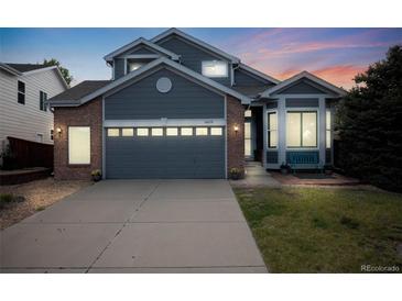 Charming two-story home featuring a two-car garage, manicured lawn and welcoming entryway at 16839 Trail View Cir, Parker, CO 80134
