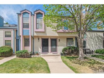 Charming townhome featuring a well-maintained lawn, mature tree, and inviting front entrance at 16104 E Alaska Pl # D, Aurora, CO 80017