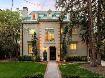 Elegant home boasts a classic design with a beautiful yard and distinctive architectural details at 165 N High St, Denver, CO 80218